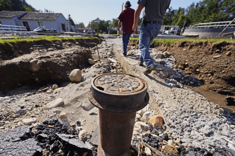 A sewer pipe is exposed due to eroded land at the wastewater treatment plant following July flooding