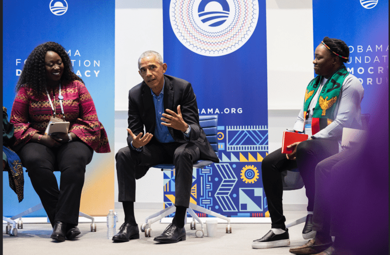 Former President Obama on stage with two members of Obama Foundation’s Leaders USA program.
