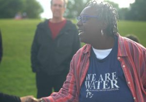 a photo of brenda coley wearing a shirt that says "We are water"