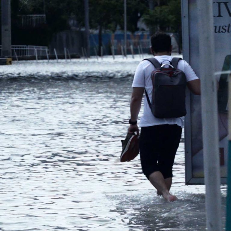 A man walking through floodwater